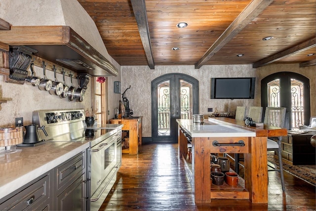 kitchen with wood ceiling, arched walkways, dark wood-style flooring, stainless steel electric range, and french doors