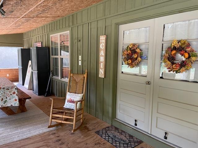 property entrance with french doors and board and batten siding