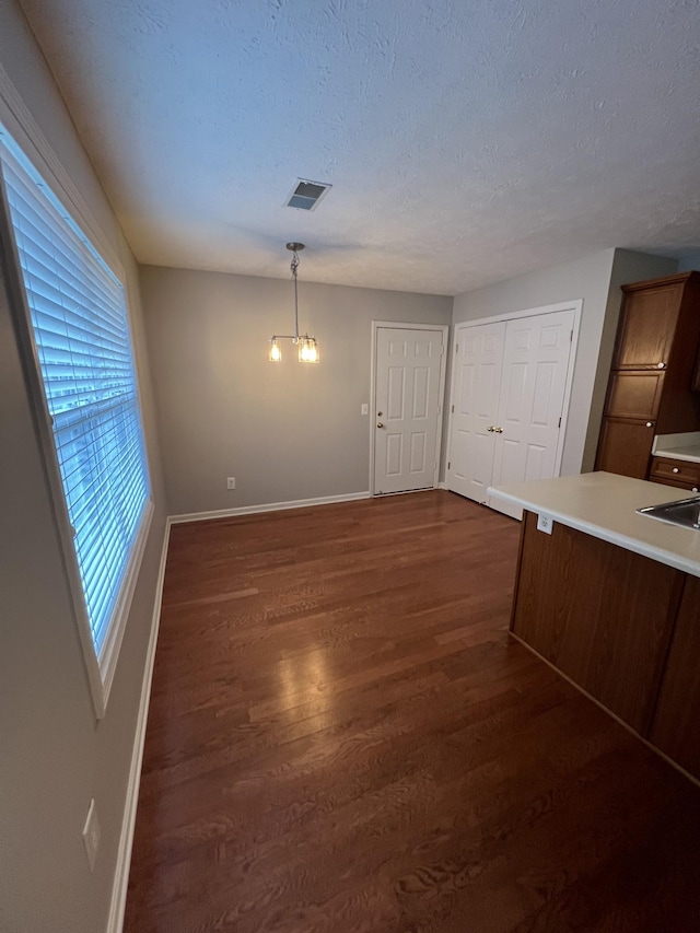 800 Browns Ln Unit L2, Gallatin, TN 37066 - unfurnished dining area featuring an inviting chandelier, dark wood finished floors, visible vents, and baseboards