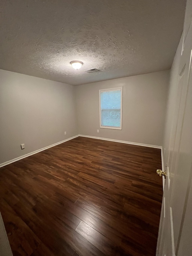 800 Browns Ln Unit L2, Gallatin, TN 37066 - spare room featuring a textured ceiling, baseboards, visible vents, and dark wood finished floors