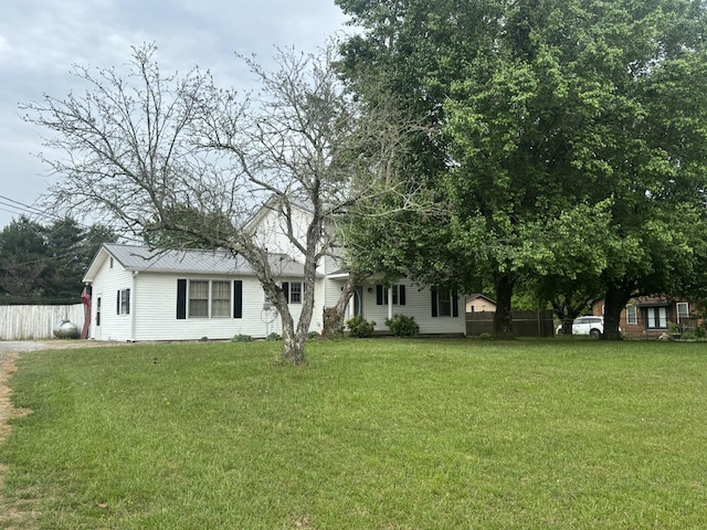 view of front facade with a front lawn and fence