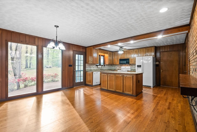 1331 Hutcheson Ln, Clarksville, TN 37040 - kitchen with wooden walls, light countertops, and white appliances