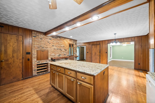 1331 Hutcheson Ln, Clarksville, TN 37040 - kitchen with wooden walls, a ceiling fan, and a kitchen island