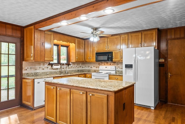 1331 Hutcheson Ln, Clarksville, TN 37040 - kitchen featuring tasteful backsplash, white appliances, brown cabinetry, ceiling fan, and a sink
