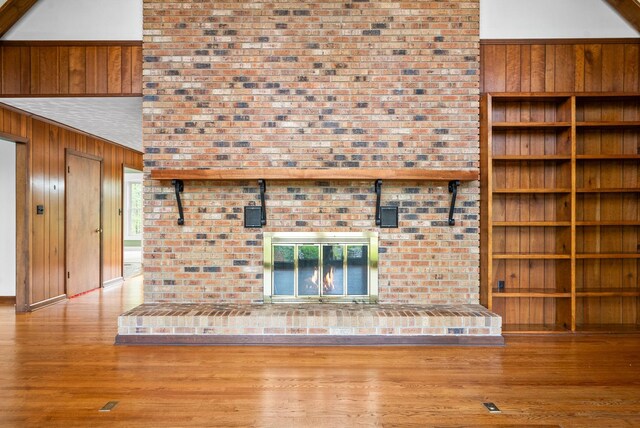 1331 Hutcheson Ln, Clarksville, TN 37040 - unfurnished living room with wood walls, wood finished floors, and built in shelves