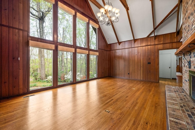 1331 Hutcheson Ln, Clarksville, TN 37040 - unfurnished living room with a fireplace, wood walls, high vaulted ceiling, and beamed ceiling