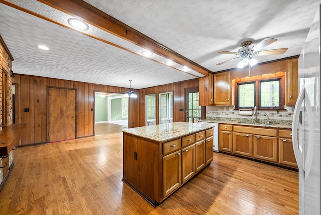 1331 Hutcheson Ln, Clarksville, TN 37040 - kitchen with light wood-type flooring, brown cabinetry, a ceiling fan, and a sink