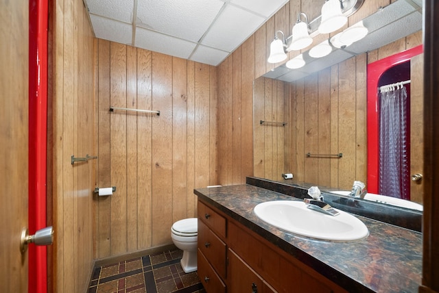 1331 Hutcheson Ln, Clarksville, TN 37040 - bathroom with vanity, tile patterned floors, toilet, wood walls, and a drop ceiling