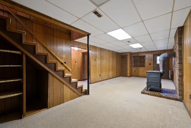1331 Hutcheson Ln, Clarksville, TN 37040 - finished below grade area with stairs, carpet floors, a drop ceiling, wood walls, and a wood stove
