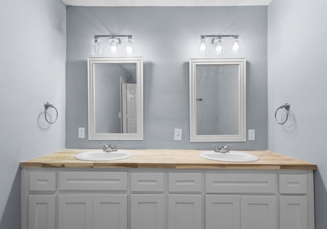 full bath with double vanity and a sink