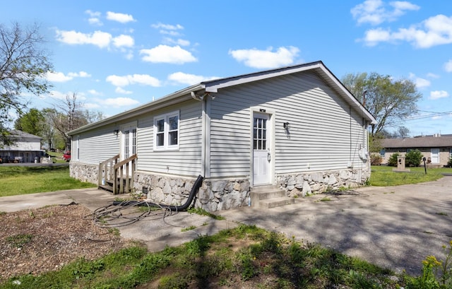 view of side of property with a patio and entry steps