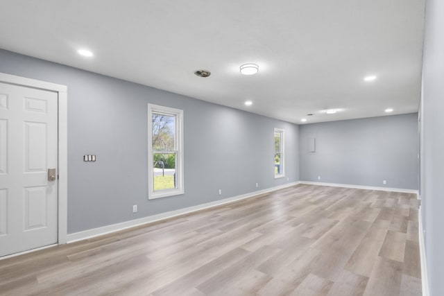 interior space with baseboards, recessed lighting, and light wood-style floors
