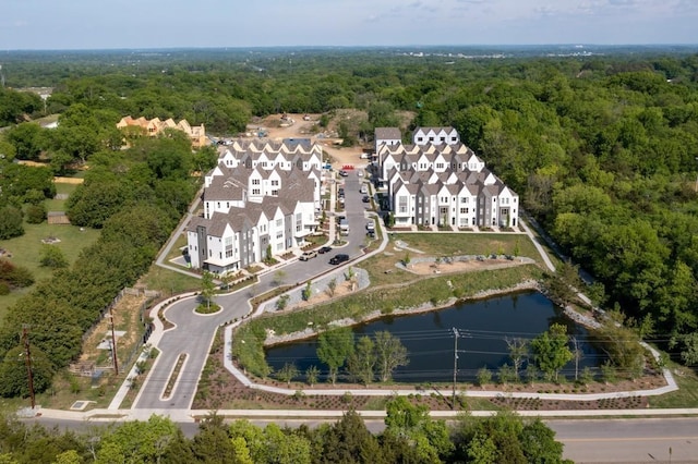 birds eye view of property with a water view and a view of trees