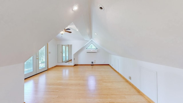 bonus room featuring lofted ceiling, a ceiling fan, light wood finished floors, and baseboards