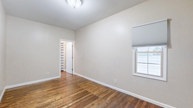 empty room with wood finished floors and baseboards