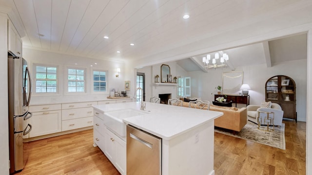 kitchen featuring a sink, a wealth of natural light, stainless steel appliances, and light wood-type flooring