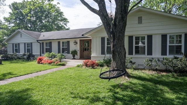 single story home featuring a front lawn, board and batten siding, and brick siding