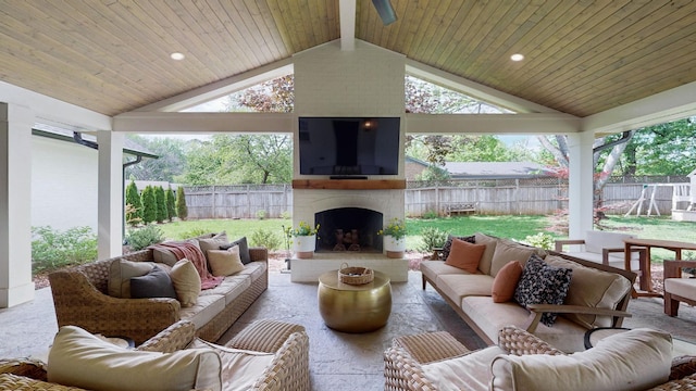 view of patio / terrace featuring an outdoor living space with a fireplace and a fenced backyard