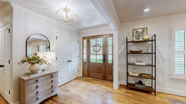 entrance foyer with light wood-style floors, a chandelier, and a healthy amount of sunlight
