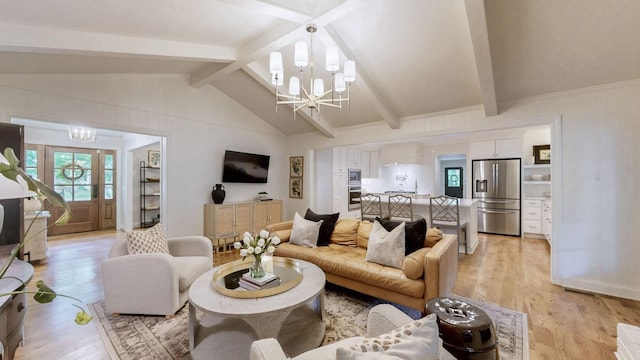 living room with an inviting chandelier, light wood-style floors, and vaulted ceiling with beams