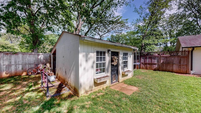 view of outbuilding featuring a fenced backyard and an outbuilding