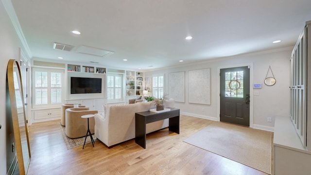 living room featuring visible vents, ornamental molding, light wood-style floors, and recessed lighting