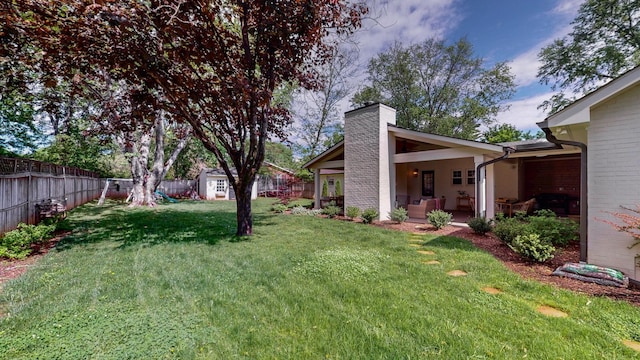view of yard featuring fence and an outdoor structure