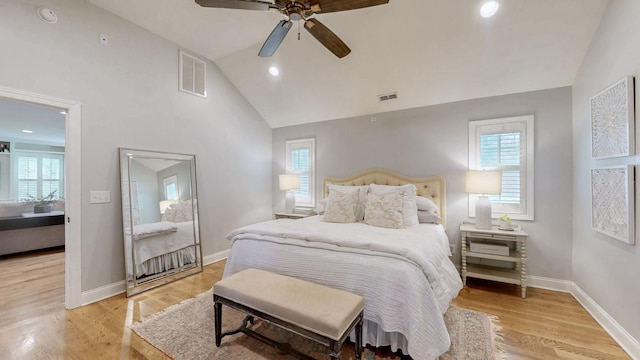 bedroom featuring visible vents, vaulted ceiling, and multiple windows