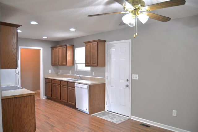 kitchen with recessed lighting, light wood-style floors, dishwasher, a sink, and a ceiling fan