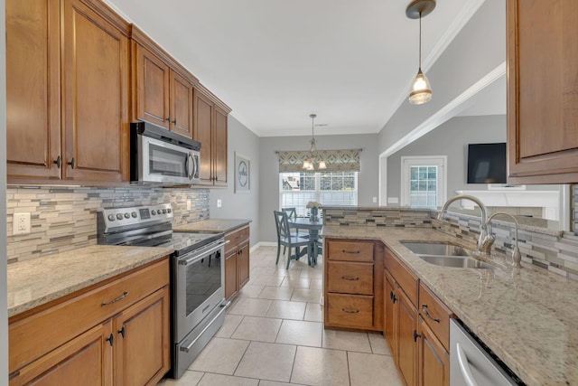kitchen featuring crown molding, a sink, backsplash, and stainless steel appliances