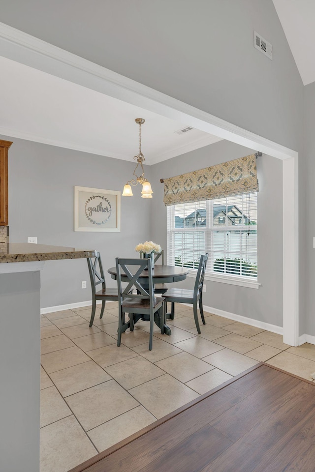 dining area with light tile patterned flooring, baseboards, visible vents, and a chandelier