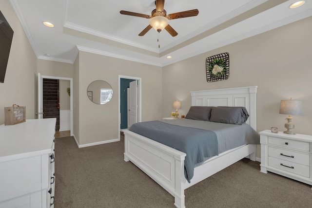 bedroom featuring dark carpet, recessed lighting, crown molding, and a tray ceiling
