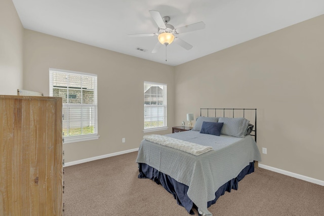 bedroom featuring carpet floors, baseboards, a ceiling fan, and visible vents