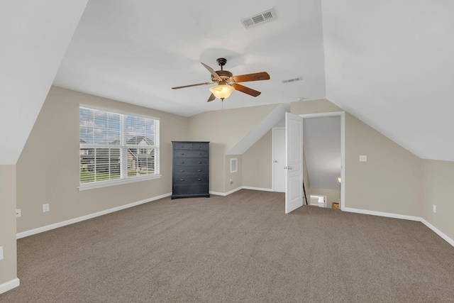 bonus room featuring a ceiling fan, visible vents, baseboards, lofted ceiling, and carpet