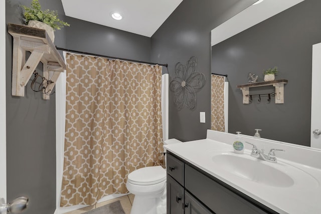 bathroom with vanity, tile patterned floors, toilet, and curtained shower