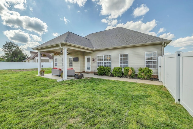 rear view of house with a ceiling fan, a lawn, a fenced backyard, a patio, and outdoor lounge area