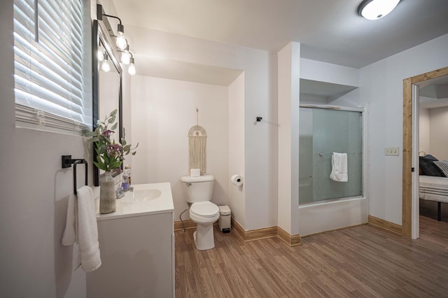 2281 Jefferson Rd, Smithville, TN 37166 - bathroom featuring vanity, bath / shower combo with glass door, toilet, baseboards, and wood finished floors