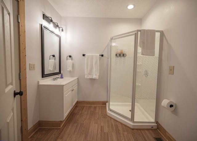 2281 Jefferson Rd, Smithville, TN 37166 - full bathroom with baseboards, wood finished floors, a stall shower, and vanity
