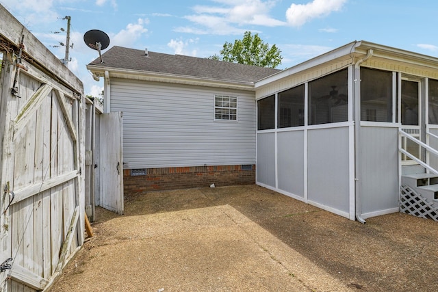 view of property exterior with a sunroom, a shingled roof, and crawl space