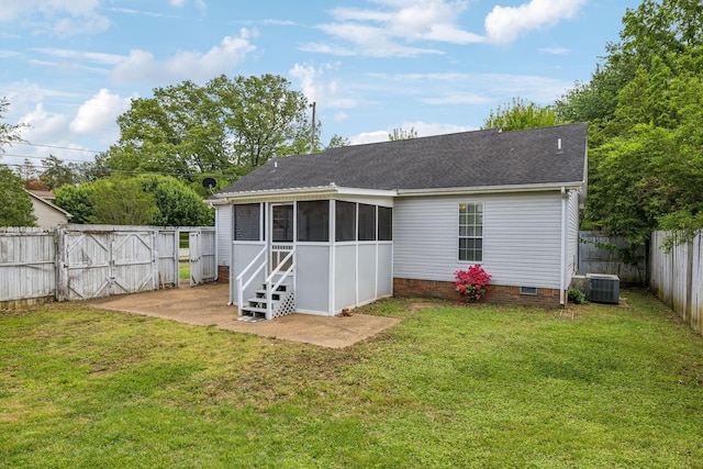 rear view of property featuring a gate, a sunroom, central AC, a fenced backyard, and a yard