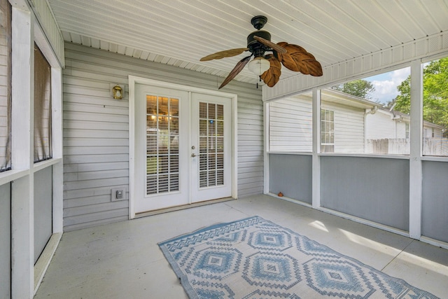 unfurnished sunroom with ceiling fan and french doors