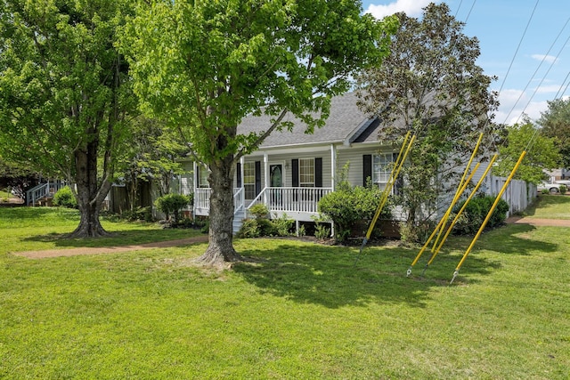 view of front of home with a porch, a shingled roof, and a front yard
