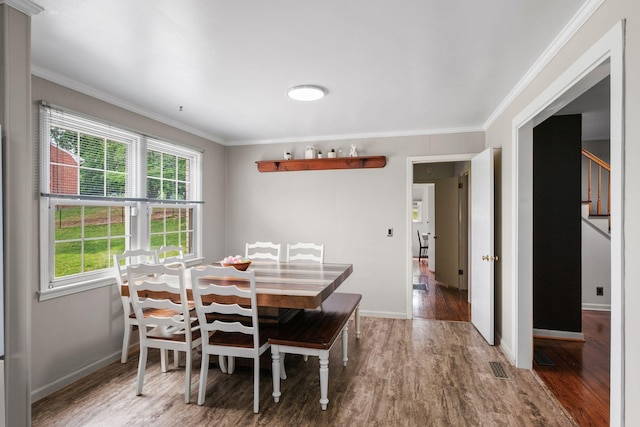 93 Hilltop Dr, Columbia, TN 38401 - dining room featuring visible vents, ornamental molding, wood finished floors, baseboards, and stairway