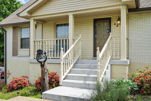 93 Hilltop Dr, Columbia, TN 38401 - property entrance featuring roof with shingles, a porch, and brick siding