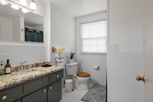93 Hilltop Dr, Columbia, TN 38401 - bathroom featuring walk in shower, a wainscoted wall, toilet, and tile walls