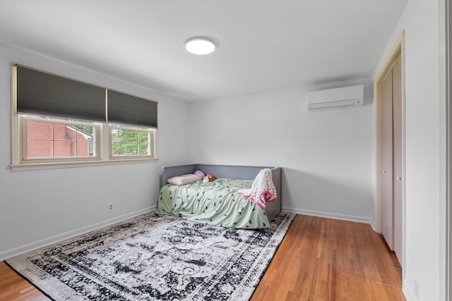 93 Hilltop Dr, Columbia, TN 38401 - bedroom featuring baseboards, a wall mounted air conditioner, and wood finished floors