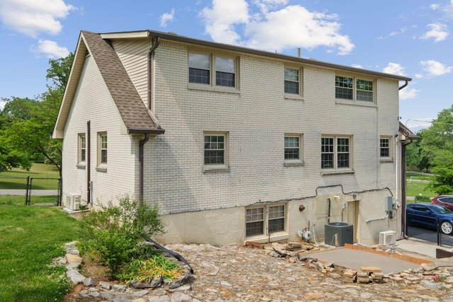 93 Hilltop Dr, Columbia, TN 38401 - back of property featuring fence, cooling unit, brick siding, ac unit, and a yard