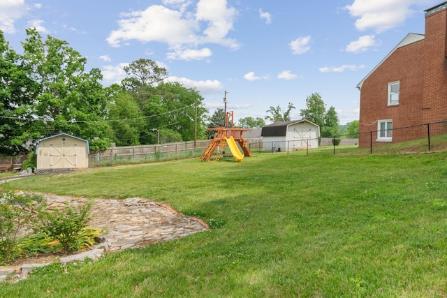93 Hilltop Dr, Columbia, TN 38401 - view of yard featuring a storage unit, a fenced backyard, a playground, and an outdoor structure