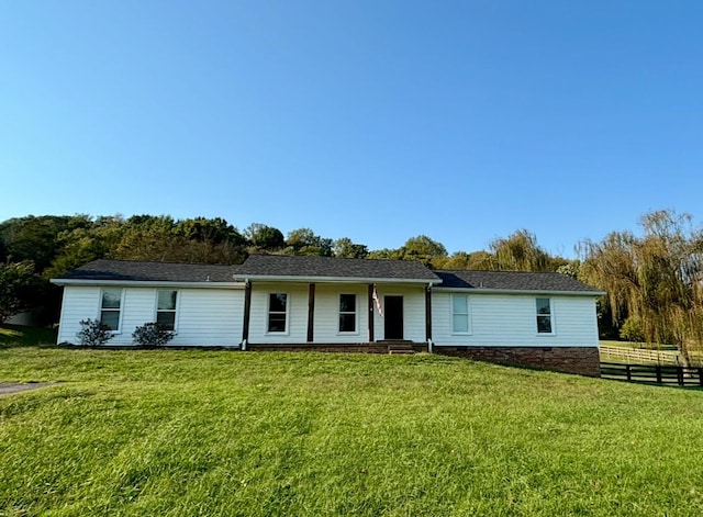 view of front of property with a front lawn and fence