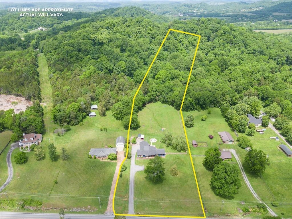 bird's eye view featuring a wooded view